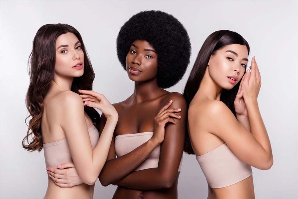 photo of three beautiful women of different ethnicities posing